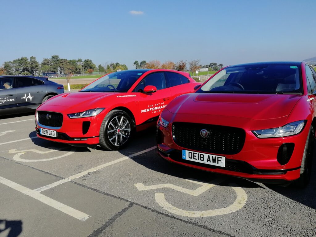 Two red Jaguar electric cars parked side by side